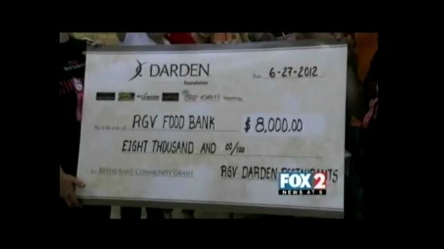 Restaurant Volunteers Stuff Food Bags for Needy
